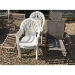 A slatted teak steamer chair, four white painted plastic chairs and,