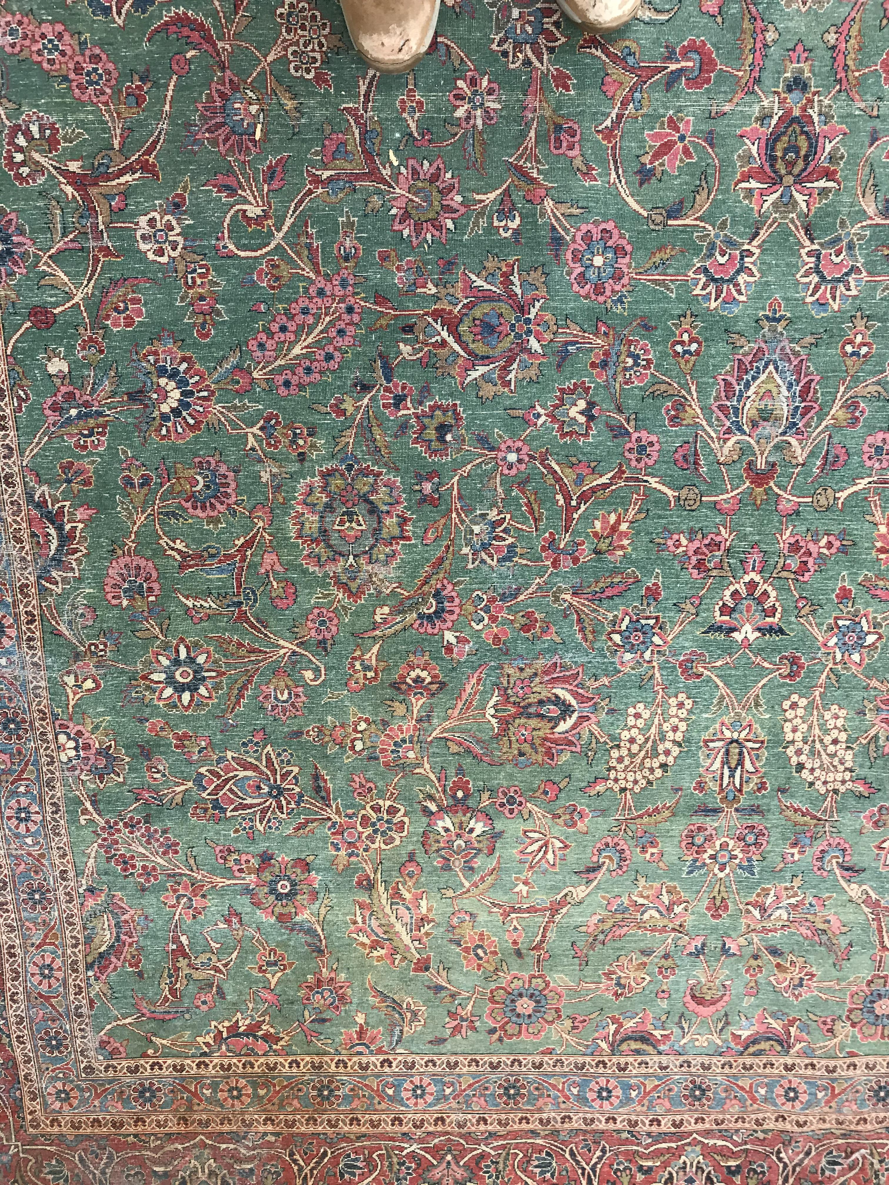 A Persian carpet, the central panel set with all-over scrolling foliate design on a teal ground, - Image 27 of 41
