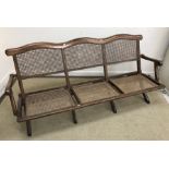 A 19th Century folding campaign settee with bergere back and seats,