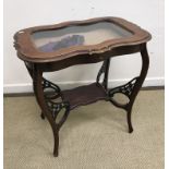 An Edwardian mahogany bijouterie table on cabriole legs united by an under tier,