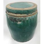 A Chinese Chiwan green glazed terracotta jar of studded barrel form with circular lid,