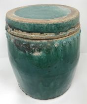 A Chinese Chiwan green glazed terracotta jar of studded barrel form with circular lid,