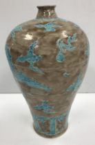 A Chinese bottle vase with brown ground set with turquoise dragon and stylised flower decoration
