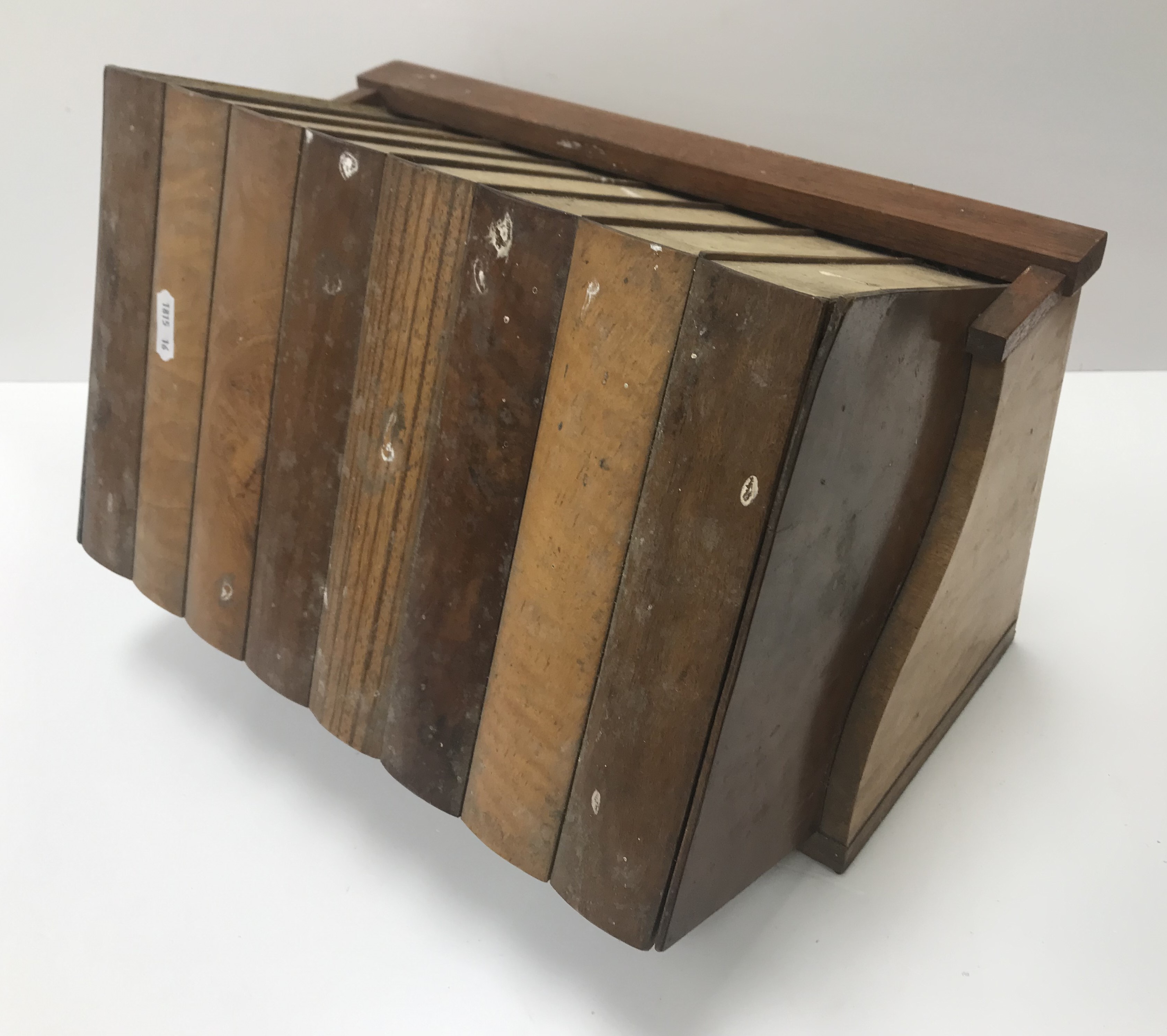 A circa 1900 sample wood box as a trough of eight books, 34.5 cm wide x 23.