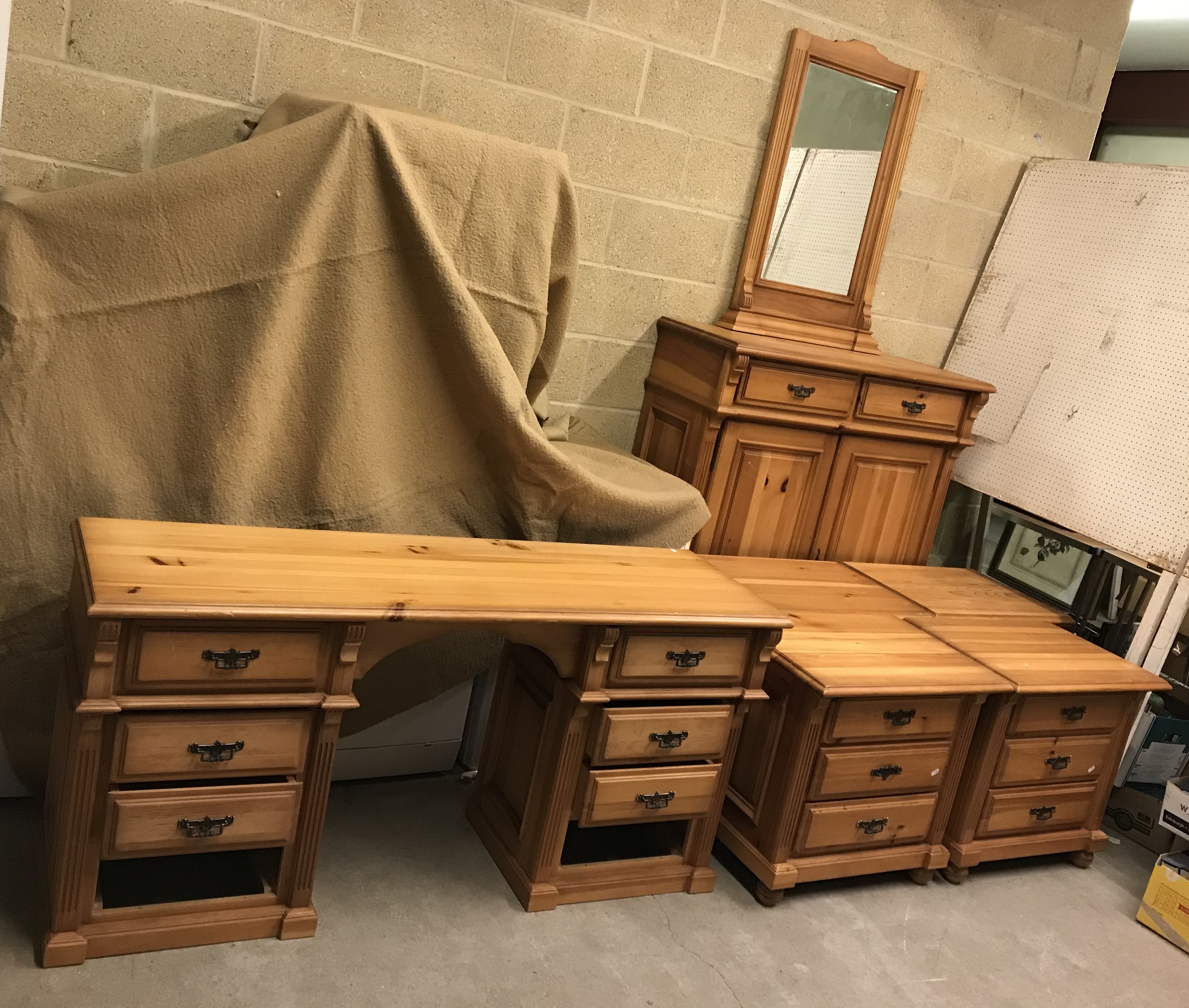 A suite of pine bedroom furniture including a set of four three drawer bedside chests,
