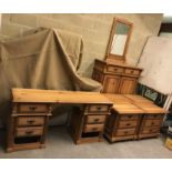 A suite of pine bedroom furniture including a set of four three drawer bedside chests,