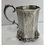 A Victorian silver waisted octagonal Christening mug with Gothic style engraved decoration raised