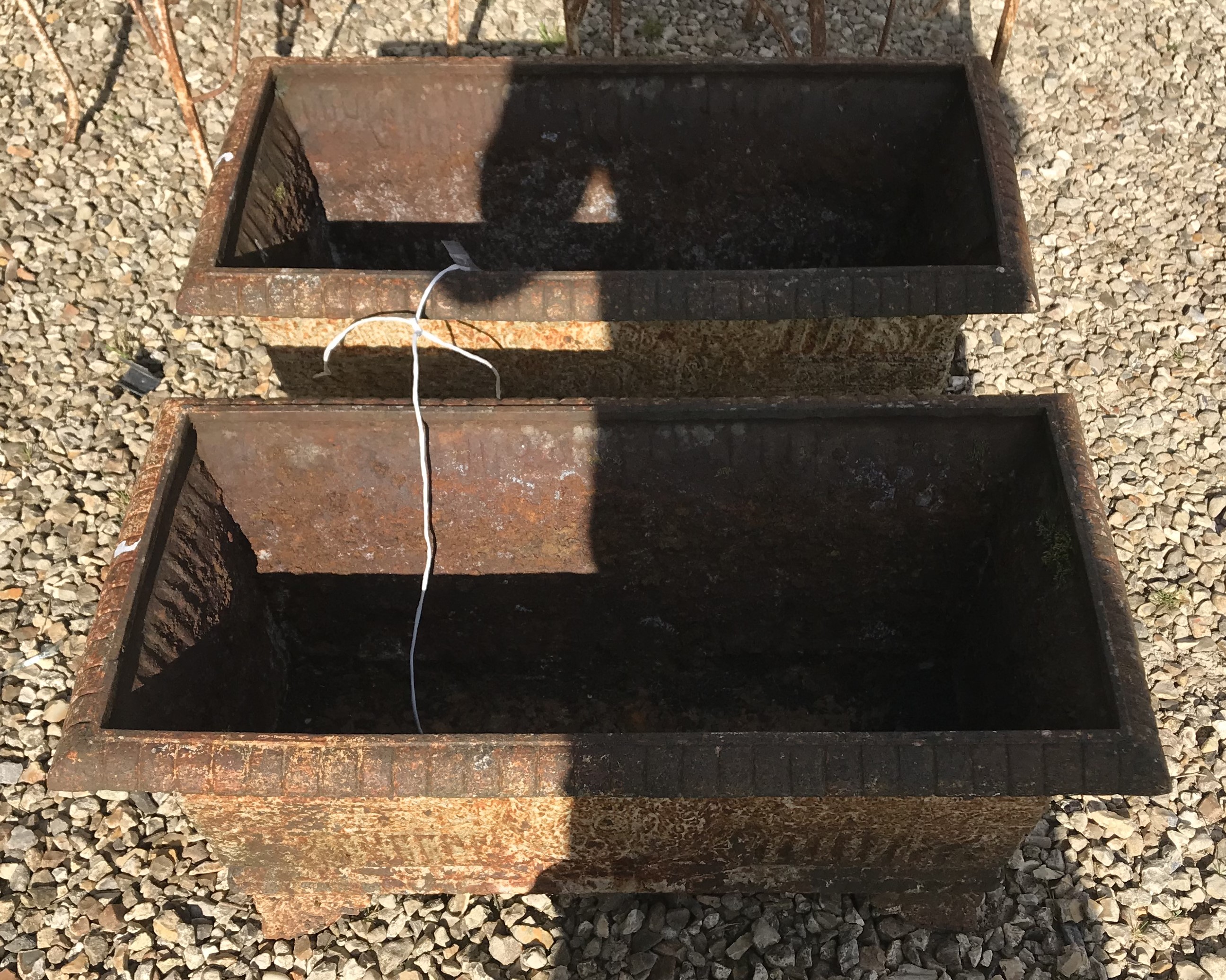 Two cast iron troughs,