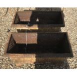 Two cast iron troughs,