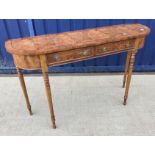 A yew wood hall side table of D end form, the plain top above two drawers on ringed and turned legs,