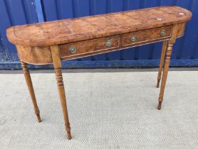 A yew wood hall side table of D end form, the plain top above two drawers on ringed and turned legs,