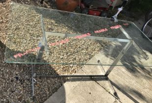 A glass top table with metal frame,