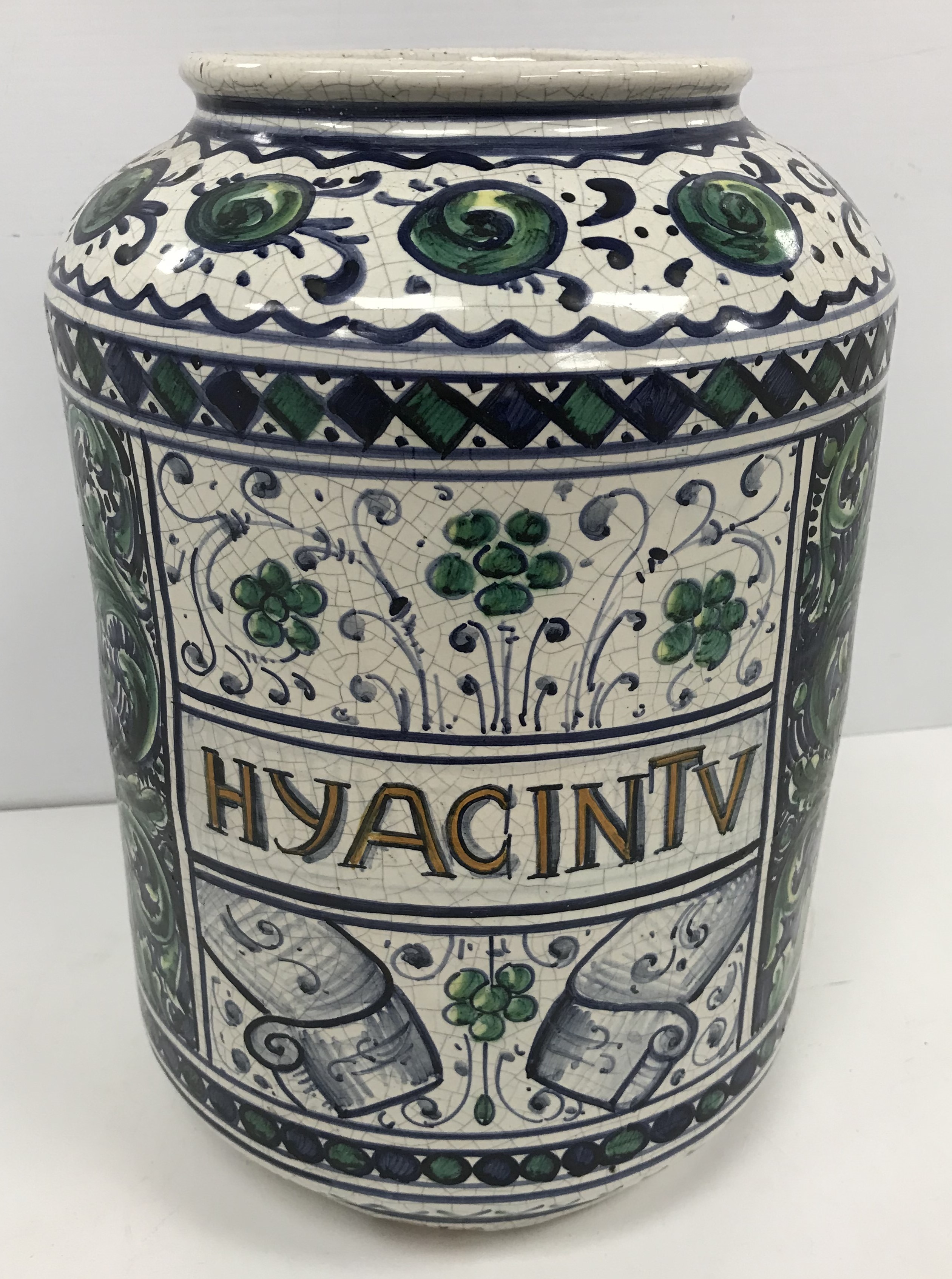 A 20th Century Persian glazed pottery pharmaceutical jar with all over floral and scrolling foliate