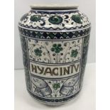 A 20th Century Persian glazed pottery pharmaceutical jar with all over floral and scrolling foliate