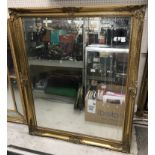 A modern rectangular swept gilt framed wall mirror with bevel edged plate in the 19th Century