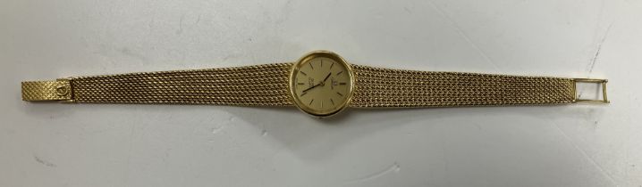 An 18 carat gold cased ladies Omega de Ville quartz wristwatch with 18 carat gold wrist band,