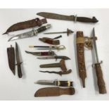 A collection of various daggers and miniature swords including a miniature ceremonial kukri,