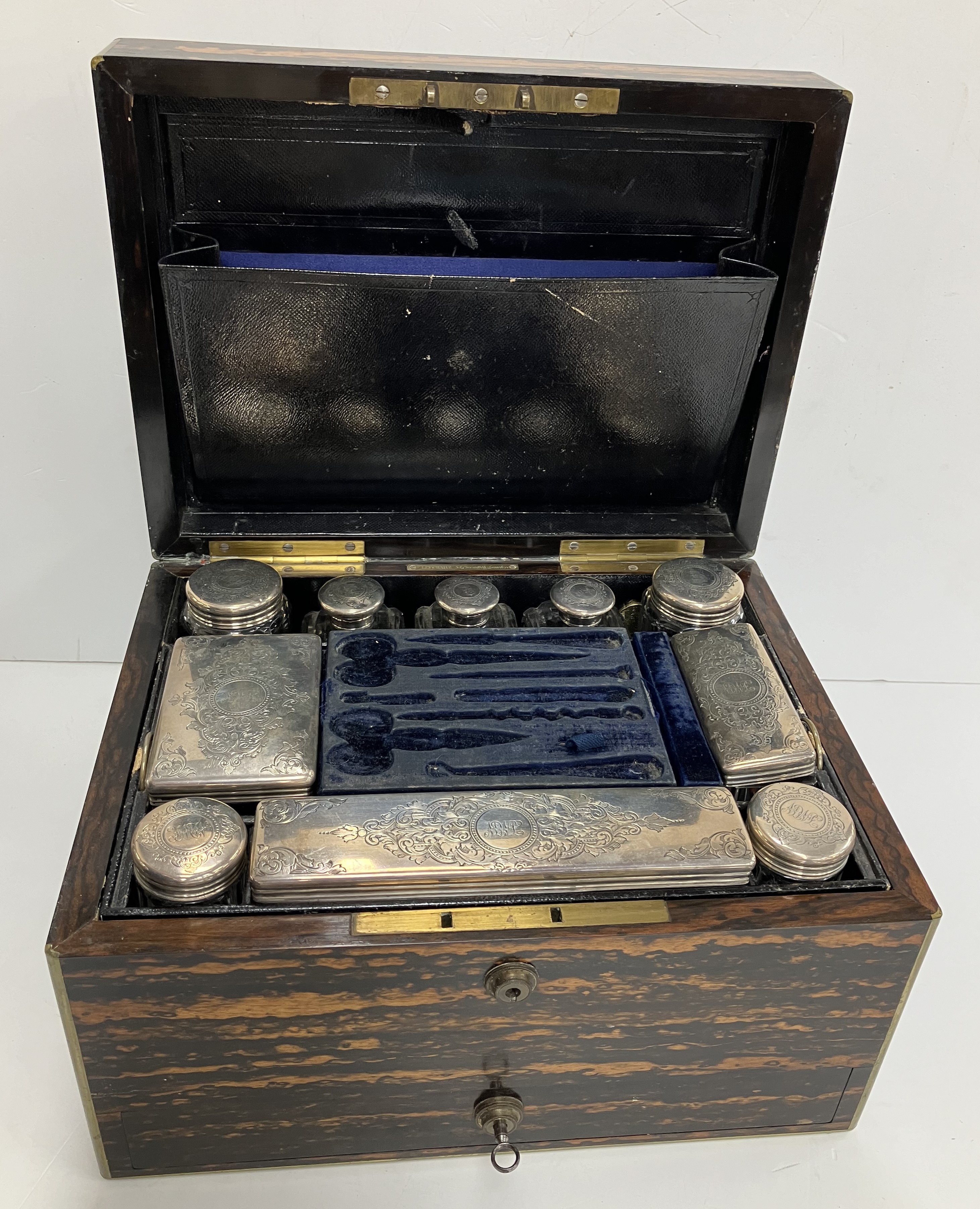 A Victorian coromandel and brass bound vanity case with cut glass and engraved silver mounted