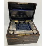 A Victorian coromandel and brass bound vanity case with cut glass and engraved silver mounted