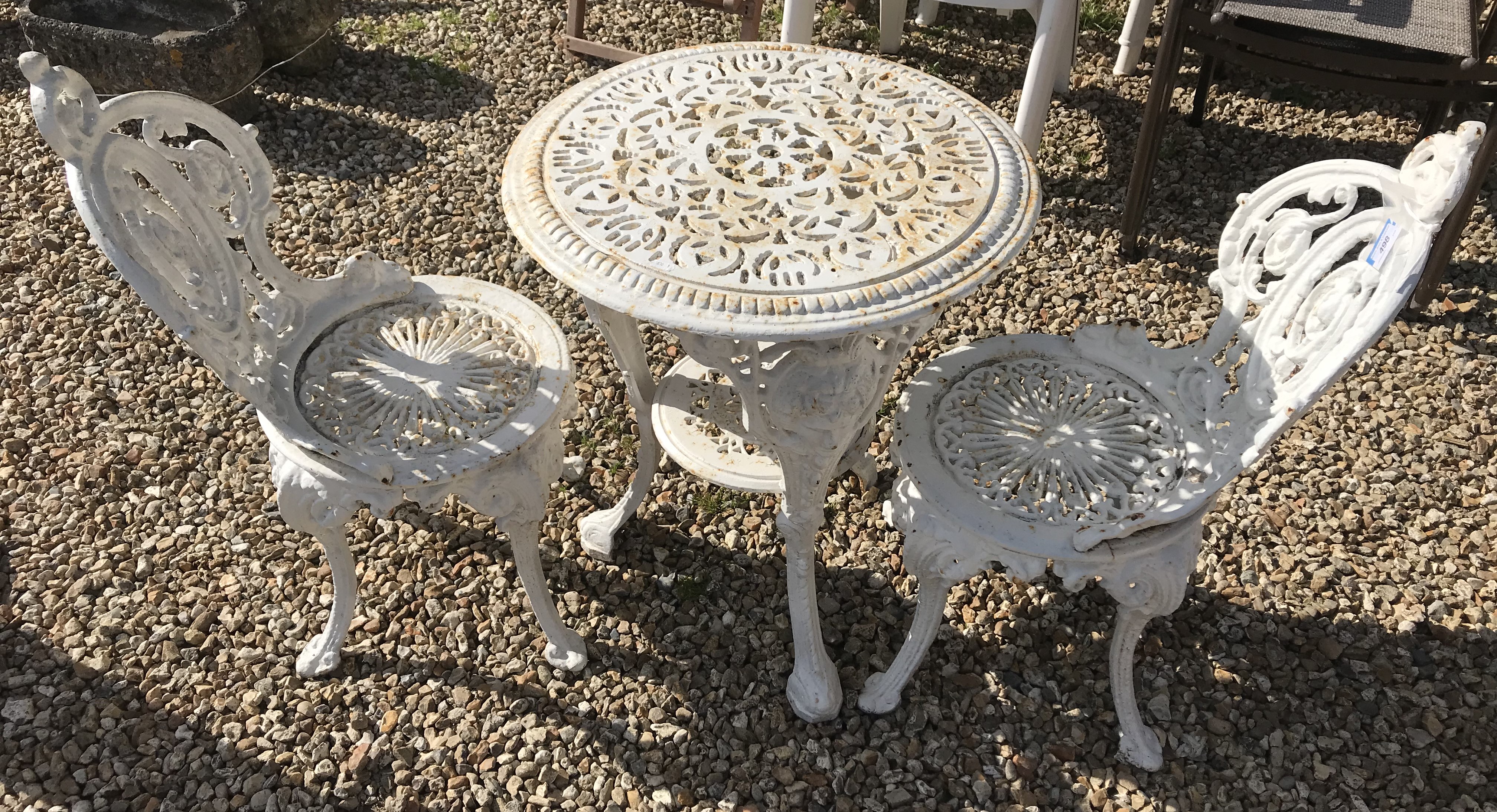 A cast iron Britannia style garden table and two chairs CONDITION REPORTS cRust is