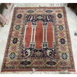 A Persian rug, the central panel set with three column design on a dark blue foliate ground,