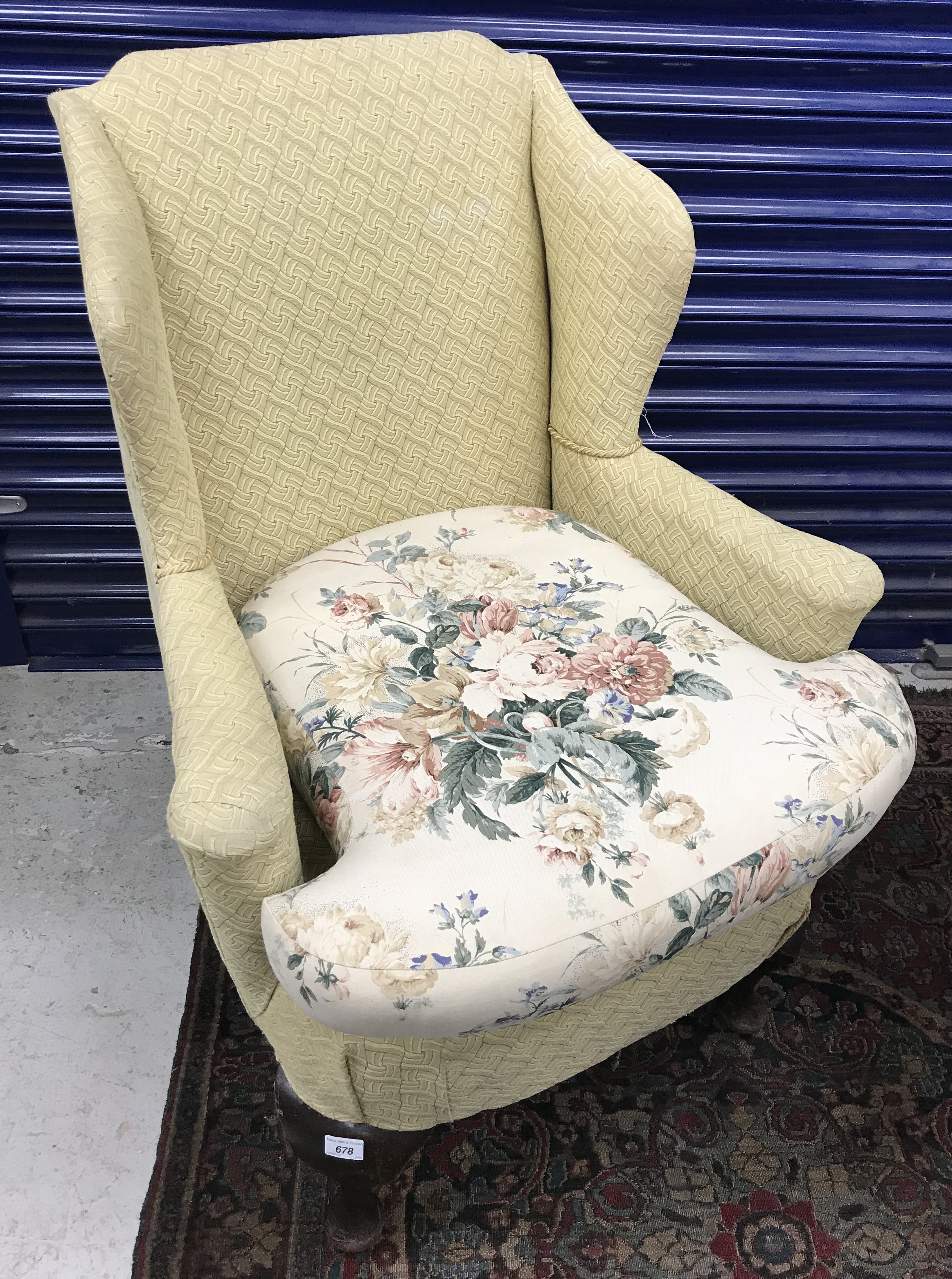 A 19th Century upholstered wing back scroll arm chair on cabriole front legs to pad feet,