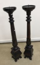 A pair of modern mahogany torchère stands, or pricket candlesticks,