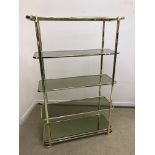 A mid to late 20th Century brass and smoked glass etagere or shelving unit of five tiers with