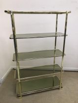 A mid to late 20th Century brass and smoked glass etagere or shelving unit of five tiers with