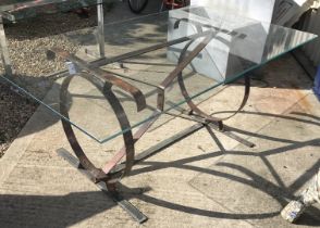 A glass top copper framed table,