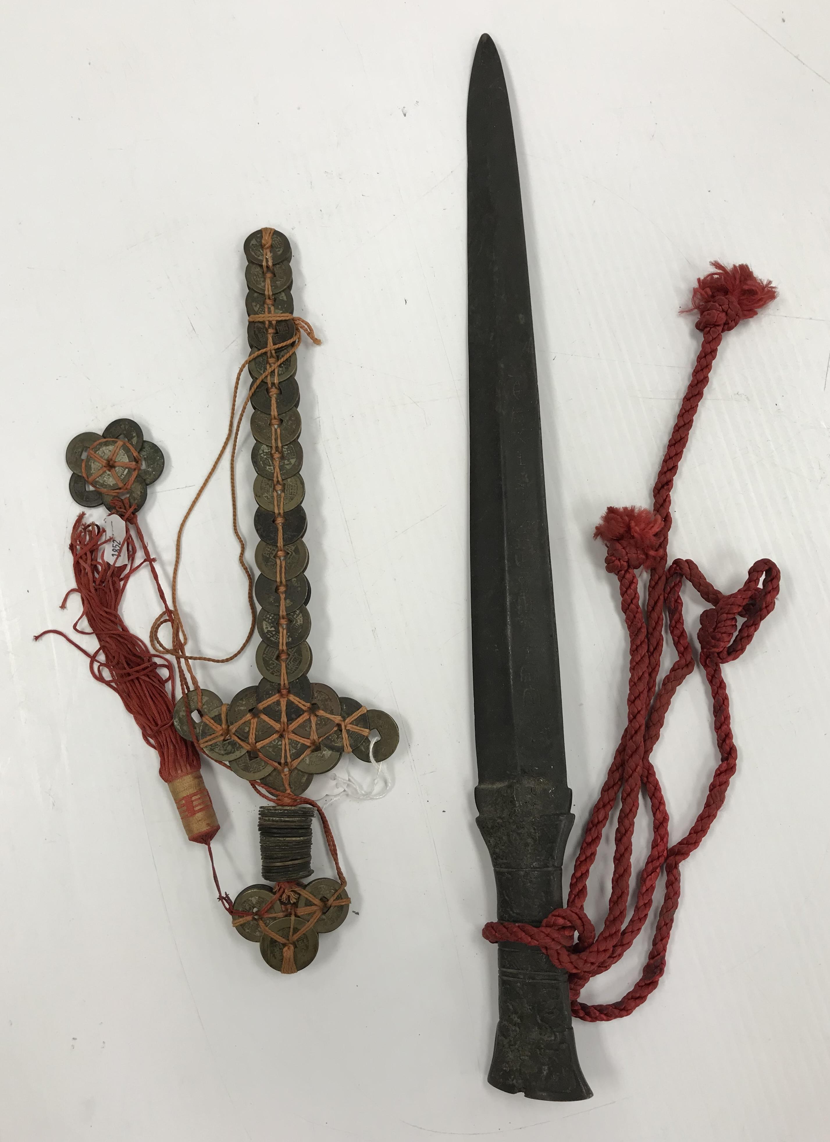 A Chinese bronze sword or dagger with integral relief work decorated handle,