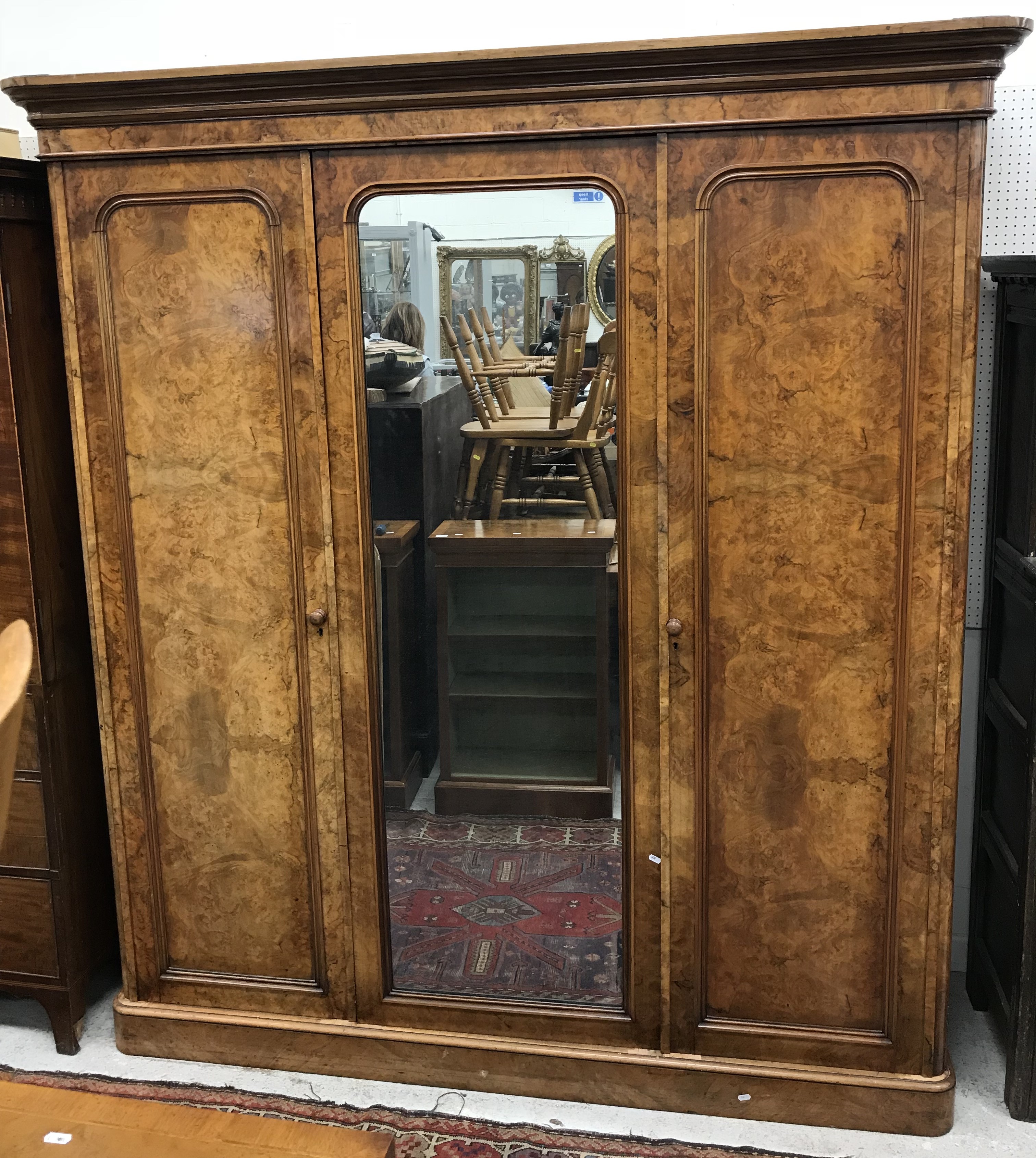 A Victorian burr walnut veneered triple wardrobe,