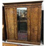 A Victorian burr walnut veneered triple wardrobe,