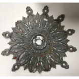 An 18th/19th Century lead ceiling rose of stylised foliate design bearing old red and white paint