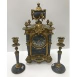 A circa 1900 brass and grey marble cased clock garniture,