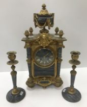 A circa 1900 brass and grey marble cased clock garniture,