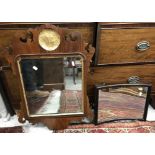 A fretwork carved walnut framed wall mirror in the early 18th Century manner with gilded medallion