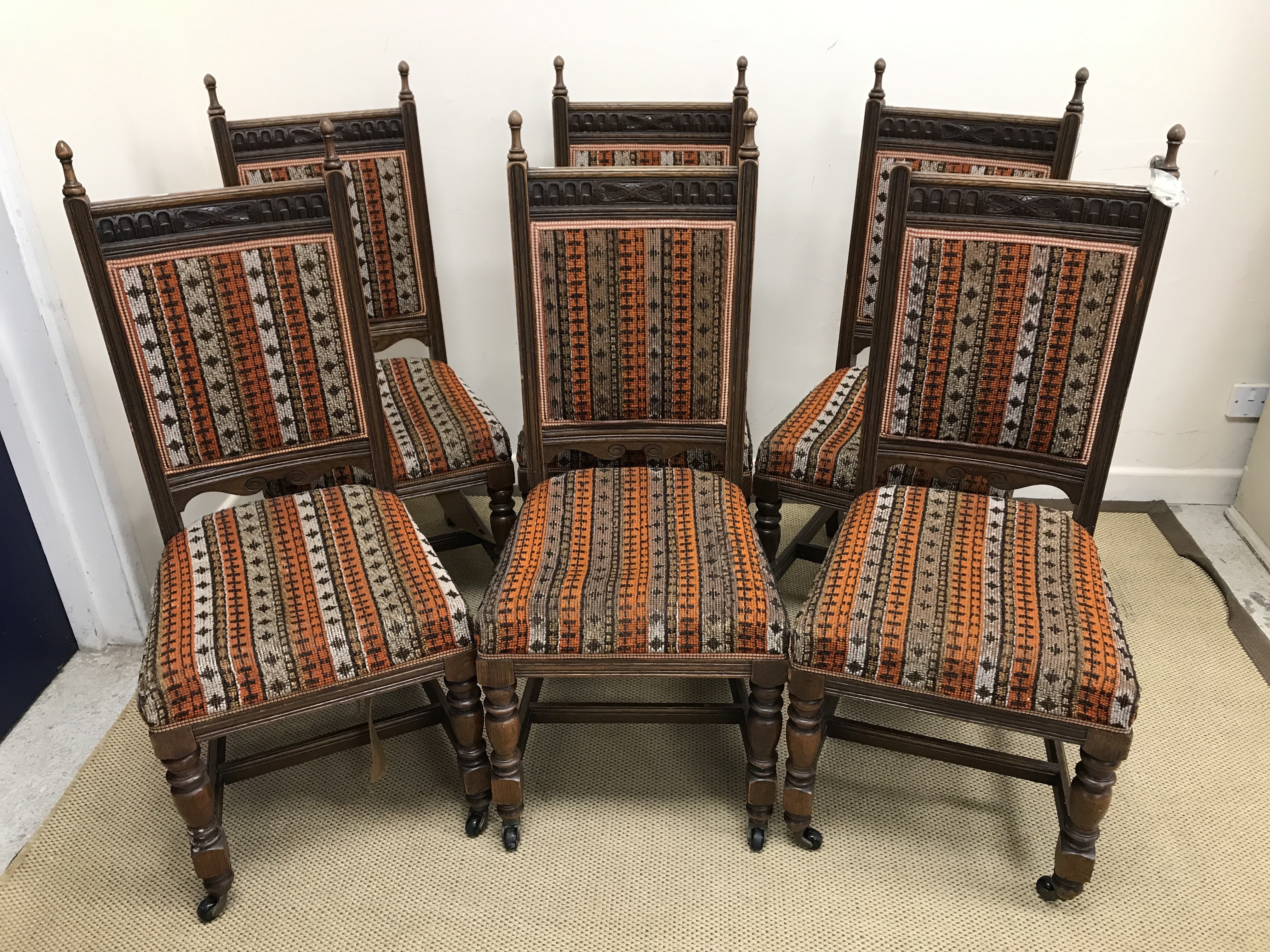 A set of six Victorian oak framed dining chairs,