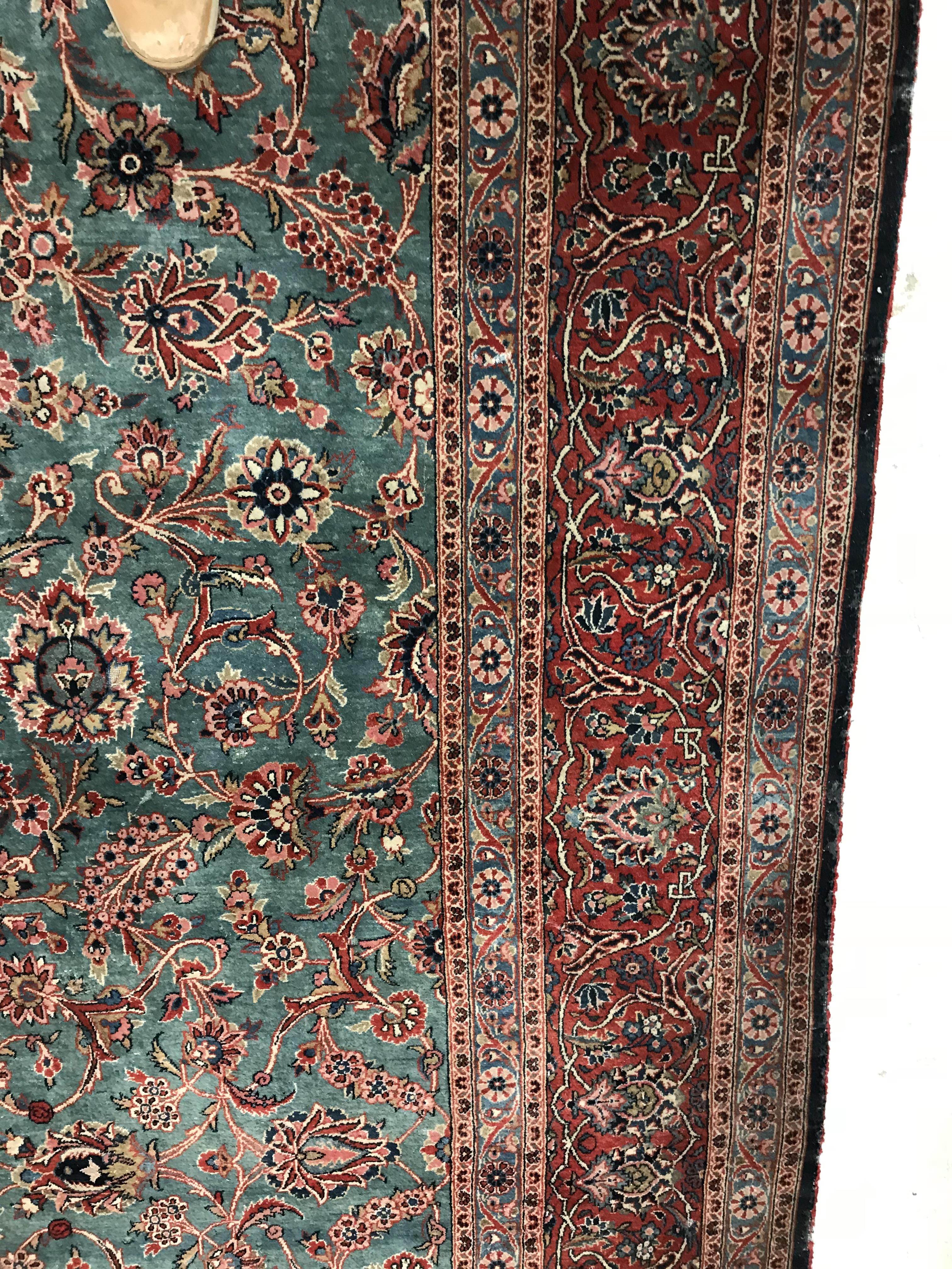 A Persian carpet, the central panel set with all-over scrolling foliate design on a teal ground, - Image 9 of 41