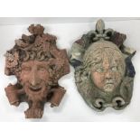 A terracotta wall plaque as the "Green man" amongst scrollwork, 30 cm x 43 cm,