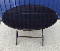 A circa 1900 circular coaching table by Thornton & Herne on a turned and ringed X frame base,