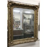 A Victorian giltwood and gesso framed rectangular overmantel mirror with plain plate,