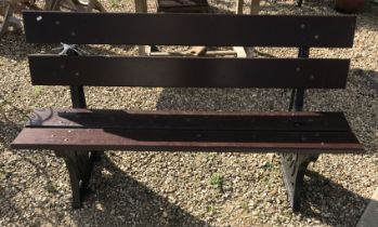 A Bristish Railways bench with wooden slats on cast iron ends 152 cm wide