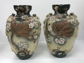 A pair of early 20th Century Japanese satsuma ware vases with relief work bird and knot decorated