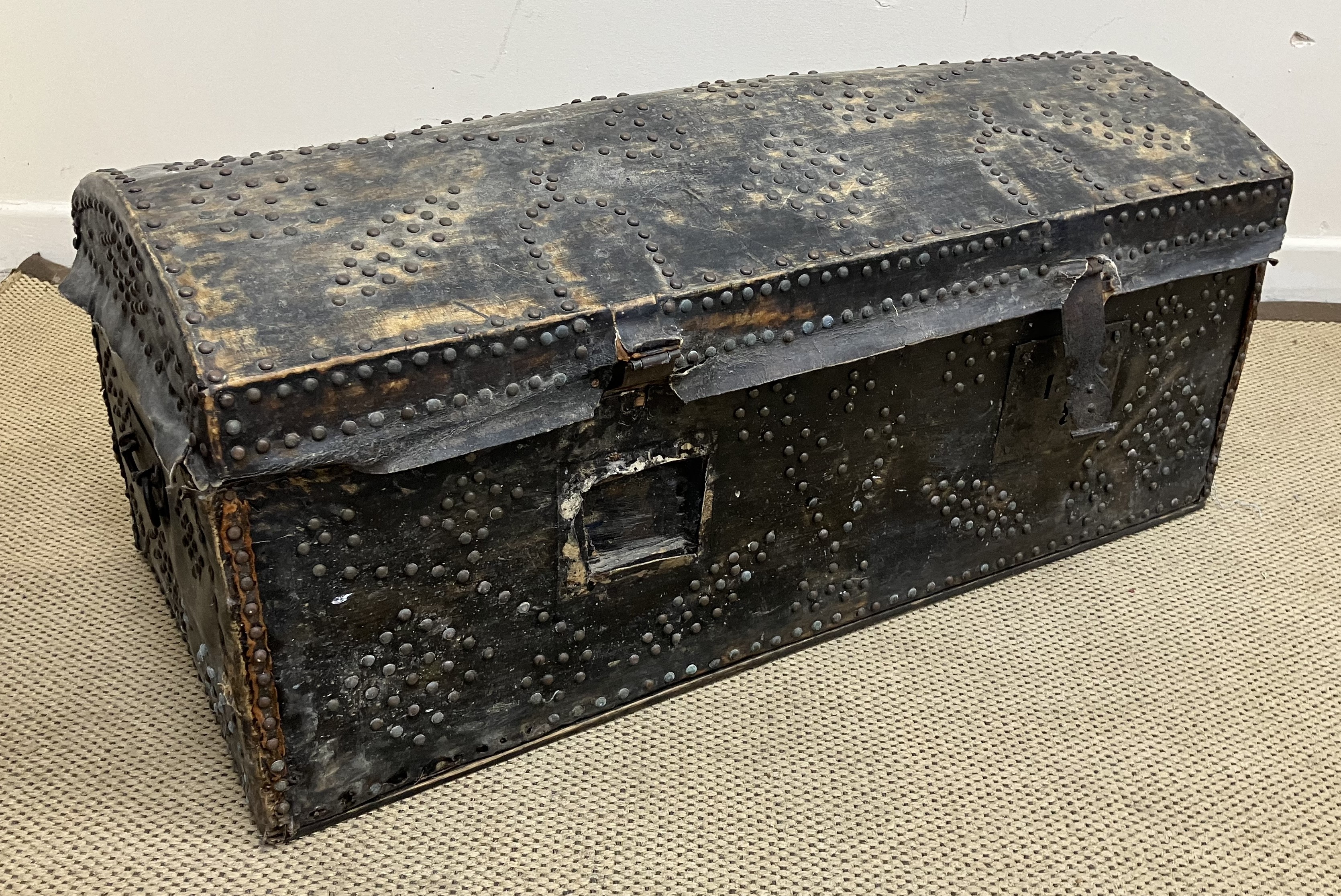 An 18th Century studded pine dome top trunk with iron carrying handles,