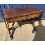 A modern reproduction mahogany and cross-banded sofa table in the Regency style and a modern