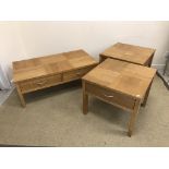 A modern oak two drawer coffee table on rectangular section supports,