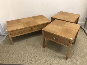 A modern oak two drawer coffee table on rectangular section supports,