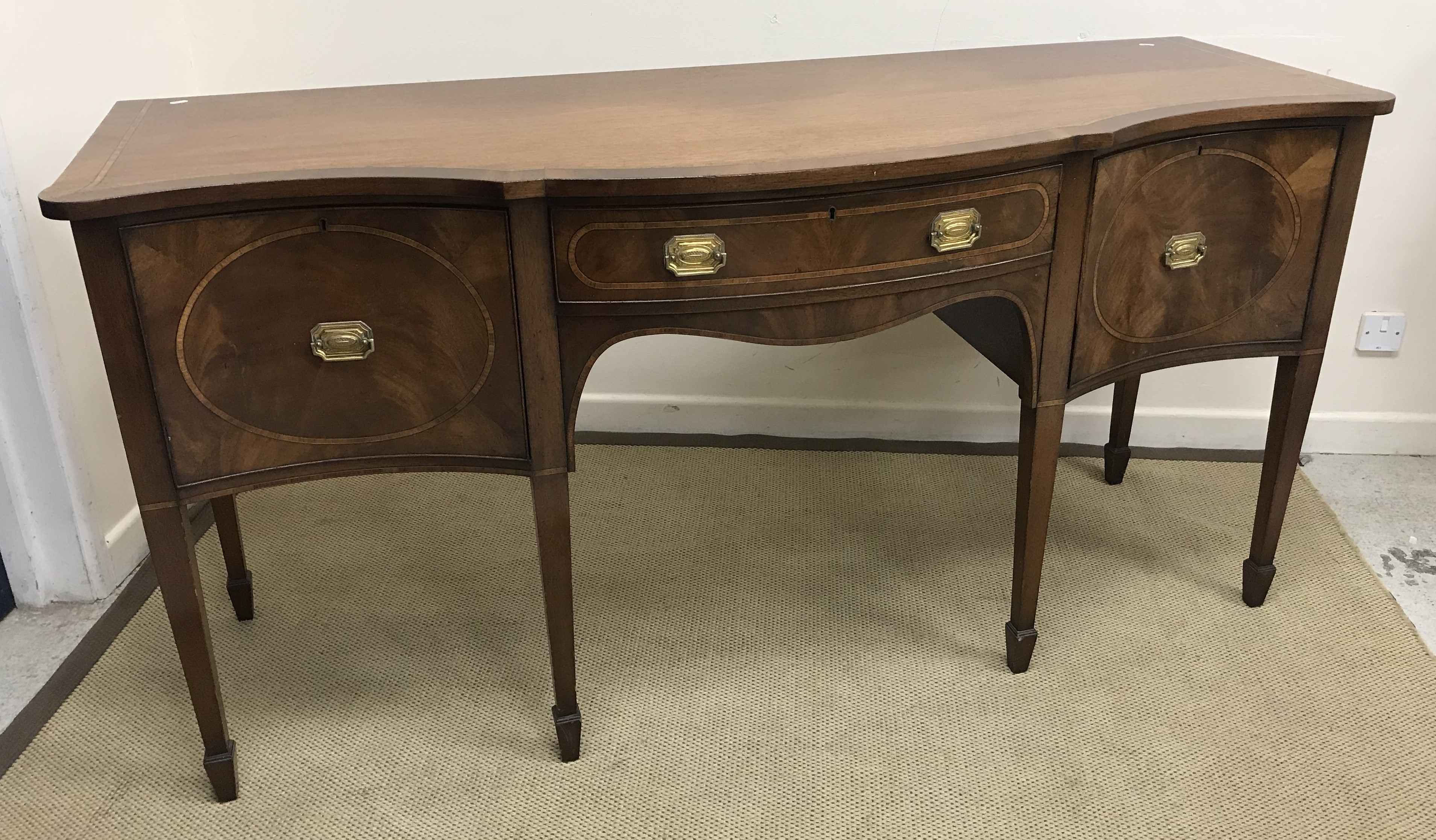 A 20th Century mahogany and inlaid breakfront sideboard in the Sheraton style with single drawer