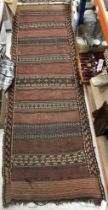 An early 20th Century Kelim rug, the central panel set with repeating red,